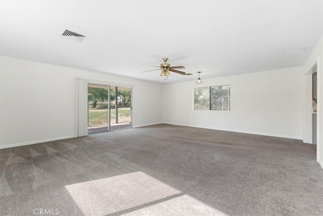 21999 Riverside Ave, Red Bluff, CA 96080 - empty room featuring healthy amount of natural light, a ceiling fan, and carpet floors