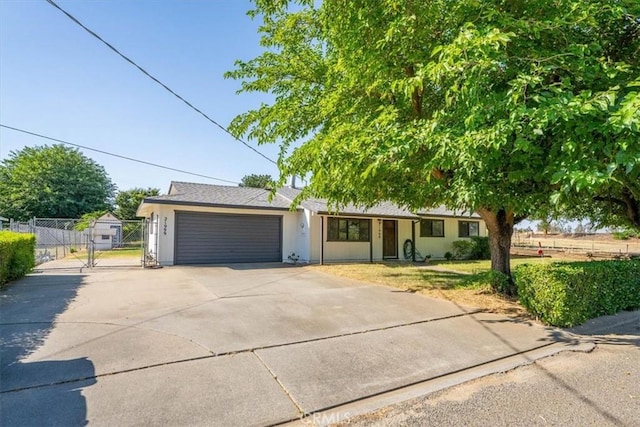 21999 Riverside Ave, Red Bluff, CA 96080 - ranch-style house with a gate, an attached garage, driveway, and stucco siding