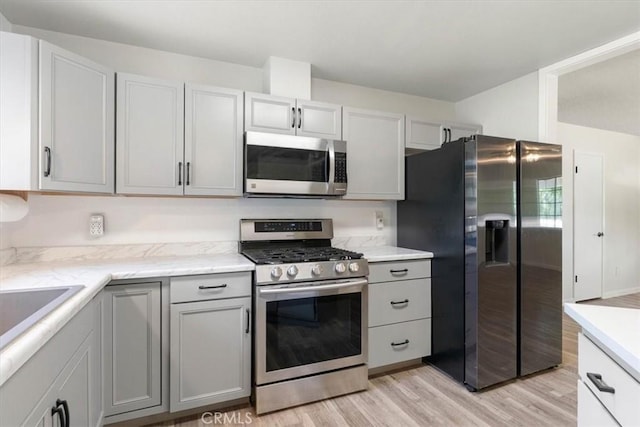 21999 Riverside Ave, Red Bluff, CA 96080 - kitchen featuring stainless steel appliances, light wood-type flooring, and gray cabinetry