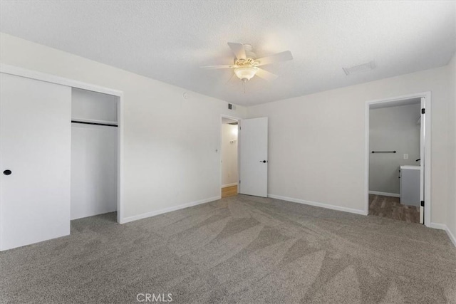 21999 Riverside Ave, Red Bluff, CA 96080 - unfurnished bedroom featuring carpet, a closet, connected bathroom, ceiling fan, and a textured ceiling