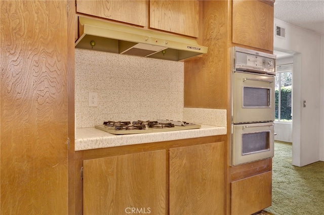 353 E Woodcroft Ave, Glendora, CA 91740 - kitchen with white appliances, under cabinet range hood, carpet flooring, decorative backsplash, and light countertops
