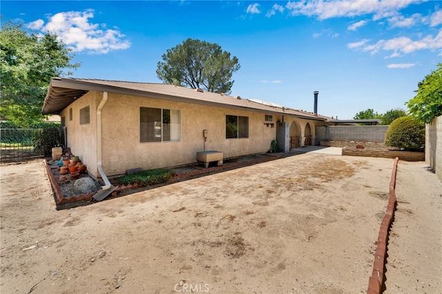 353 E Woodcroft Ave, Glendora, CA 91740 - back of property with stucco siding, a fenced backyard, and a patio