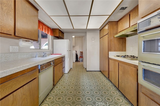 353 E Woodcroft Ave, Glendora, CA 91740 - kitchen featuring white appliances, under cabinet range hood, light countertops, and brown cabinets