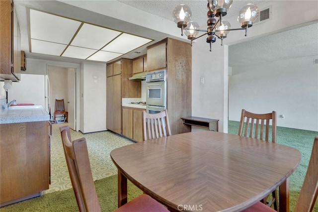 353 E Woodcroft Ave, Glendora, CA 91740 - dining area featuring a textured ceiling and a chandelier
