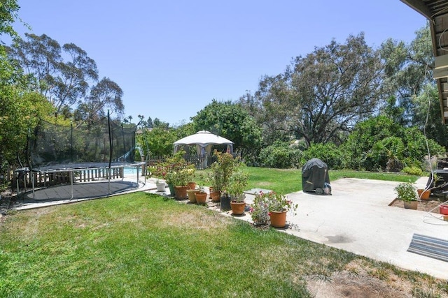 3096 Coral Tree Ln, Fallbrook, CA 92028 - view of grassy yard featuring a trampoline, a gazebo, and a patio area