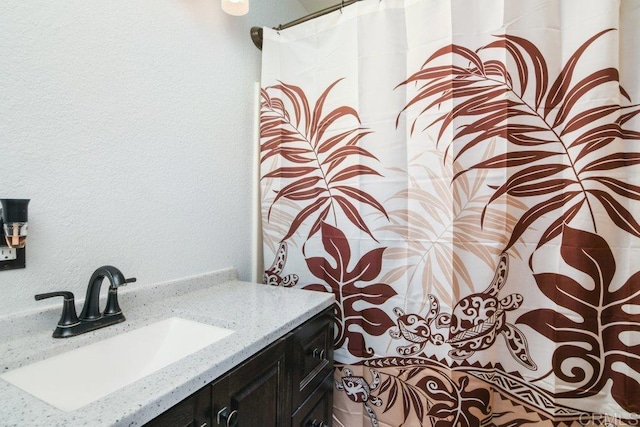 3096 Coral Tree Ln, Fallbrook, CA 92028 - full bathroom with vanity, a shower with shower curtain, and a textured wall