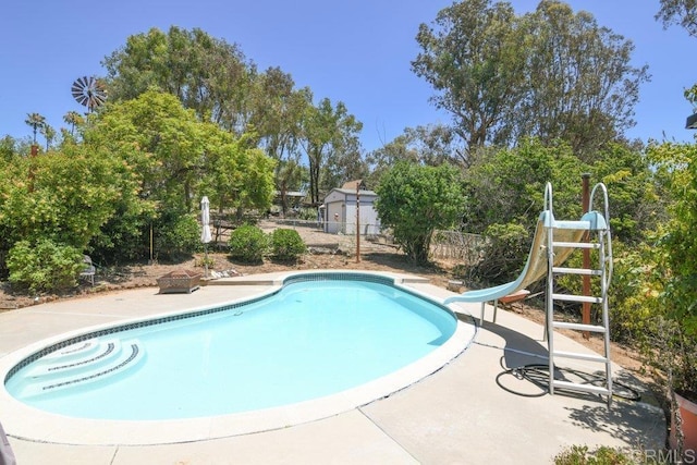 3096 Coral Tree Ln, Fallbrook, CA 92028 - outdoor pool with a water slide, a patio, and view of scattered trees