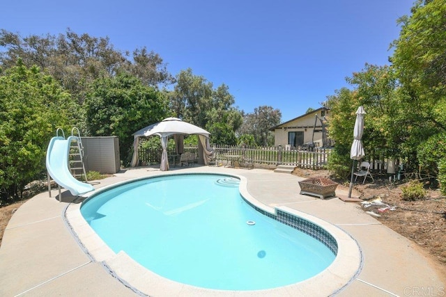 3096 Coral Tree Ln, Fallbrook, CA 92028 - view of pool with a water slide, a gazebo, a patio, and view of wooded area