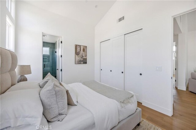 2102 Marshallfield Ln Unit A, Redondo Beach, CA 90278 - bedroom with wood finished floors, high vaulted ceiling, a closet, and connected bathroom