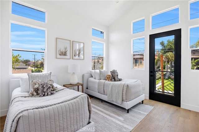 2102 Marshallfield Ln Unit A, Redondo Beach, CA 90278 - bedroom featuring light wood-style flooring, access to exterior, and high vaulted ceiling