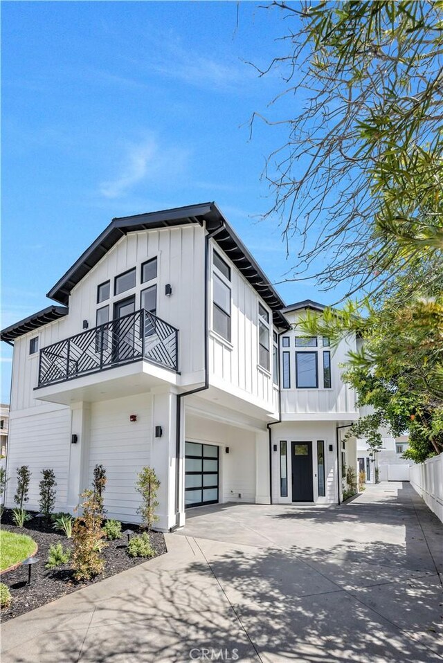 2102 Marshallfield Ln Unit A, Redondo Beach, CA 90278 - modern inspired farmhouse featuring a balcony, board and batten siding, an attached garage, and driveway