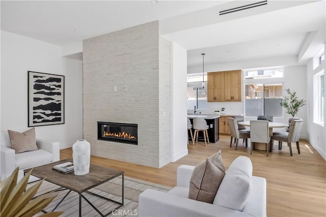 2102 Marshallfield Ln Unit A, Redondo Beach, CA 90278 - living room with light wood-type flooring and a fireplace