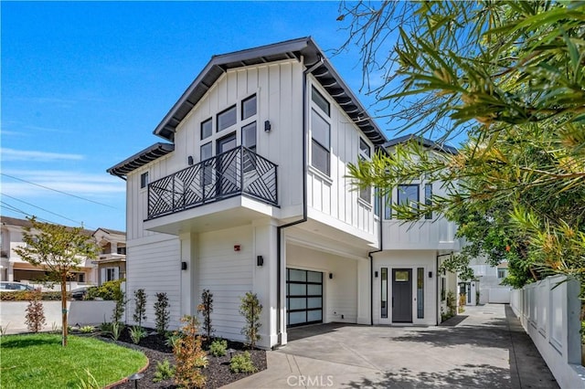 2102 Marshallfield Ln Unit A, Redondo Beach, CA 90278 - view of front of house featuring a balcony, an attached garage, board and batten siding, and concrete driveway