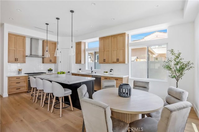 2102 Marshallfield Ln Unit A, Redondo Beach, CA 90278 - kitchen with wall chimney range hood, stainless steel appliances, a kitchen island, light wood finished floors, and recessed lighting