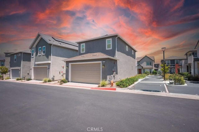 27474 Quiet View Pl, Valencia, CA 91381 - view of front facade featuring stucco siding, a garage, and a residential view