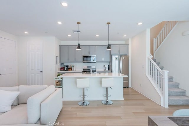 27474 Quiet View Pl, Valencia, CA 91381 - kitchen featuring stainless steel appliances, gray cabinets, light wood-style flooring, recessed lighting, and light countertops