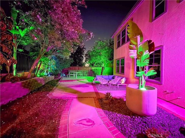 3090 Mangular Ave, Corona, CA 92882 - patio at night featuring a patio area and an outdoor hangout area