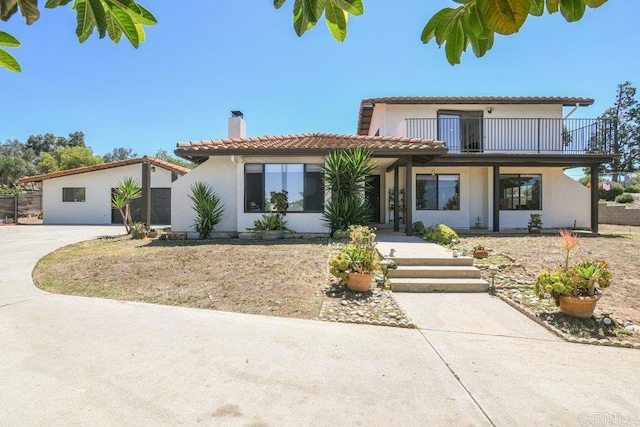 1736 Bellington Ln, Fallbrook, CA 92028 - mediterranean / spanish house with a chimney, stucco siding, a balcony, and a tile roof