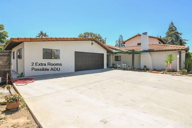 1736 Bellington Ln, Fallbrook, CA 92028 - mediterranean / spanish-style home featuring a garage, a tiled roof, driveway, and stucco siding