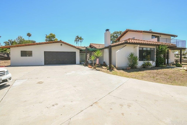 1736 Bellington Ln, Fallbrook, CA 92028 - mediterranean / spanish home featuring a chimney, a tile roof, stucco siding, and concrete driveway