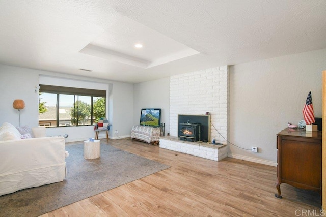 1736 Bellington Ln, Fallbrook, CA 92028 - bedroom featuring wood finished floors, a wood stove, a tray ceiling, and recessed lighting