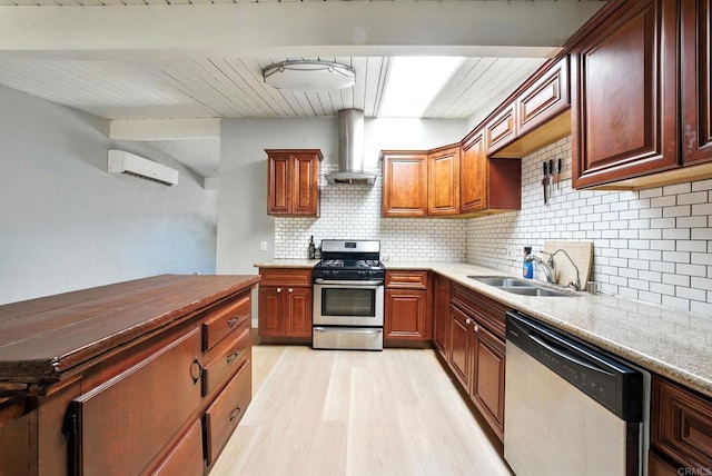 9738 Jamacha Blvd, Spring Valley, CA 91977 - kitchen featuring dishwasher, stainless steel range with gas stovetop, wall chimney range hood, a wall unit AC, and light wood-style flooring