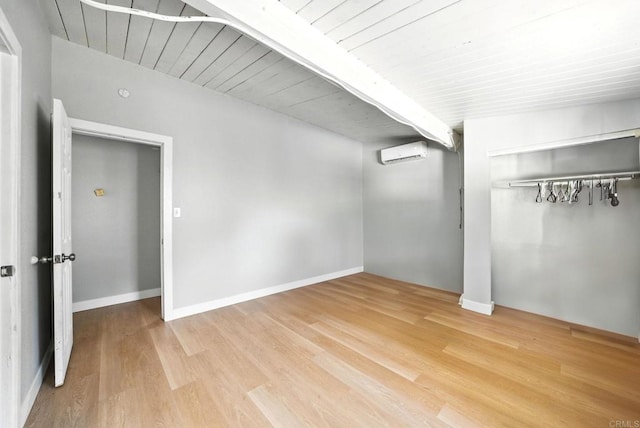 9738 Jamacha Blvd, Spring Valley, CA 91977 - unfurnished bedroom featuring a wall unit AC, a closet, wood finished floors, and a wooden ceiling with exposed beams