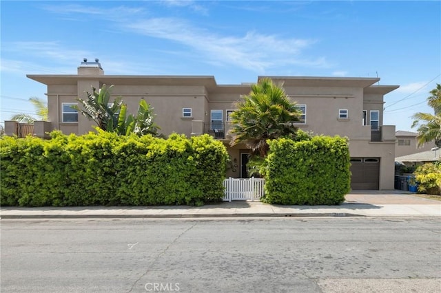 2620 Huntington Ln, Redondo Beach, CA 90278 - view of front of home with stucco siding, a garage, a chimney, and concrete driveway