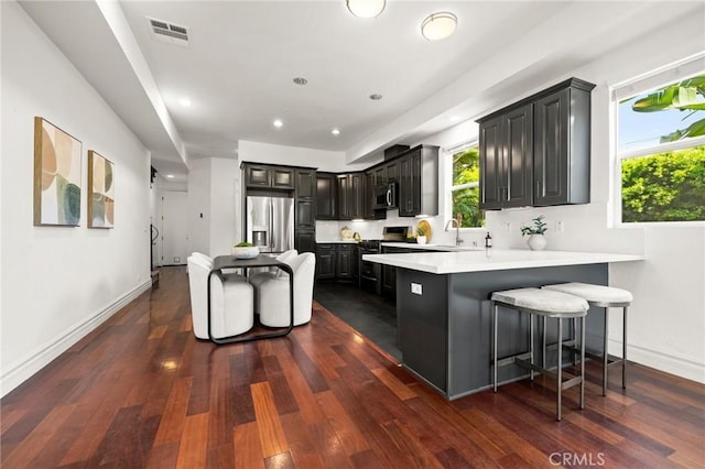 2620 Huntington Ln, Redondo Beach, CA 90278 - kitchen featuring stainless steel appliances, a peninsula, plenty of natural light, dark wood-style floors, and recessed lighting