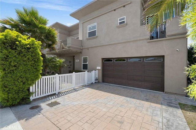 2620 Huntington Ln, Redondo Beach, CA 90278 - view of front of home with stucco siding, an attached garage, and driveway