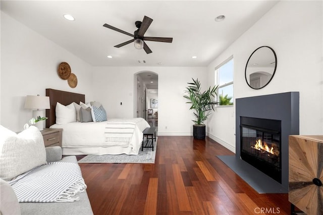 2620 Huntington Ln, Redondo Beach, CA 90278 - bedroom with wood finished floors, arched walkways, a glass covered fireplace, and recessed lighting