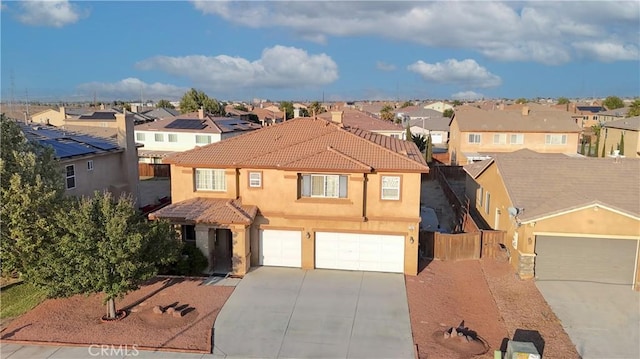 13647 Mesa Linda Ave, Victorville, CA 92392 - view of front of property featuring a residential view, driveway, a garage, a tiled roof, and stucco siding