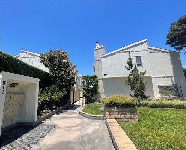 511 E Live Oak Ave Unit 11, Arcadia, CA 91006 - view of property exterior featuring mail area, a gate, and a chimney