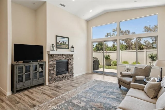 232 Loretta Way, Calimesa, CA 92320 - living area with high vaulted ceiling, wood finished floors, and a stone fireplace
