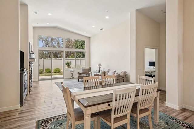 232 Loretta Way, Calimesa, CA 92320 - dining space featuring light wood-style flooring and high vaulted ceiling