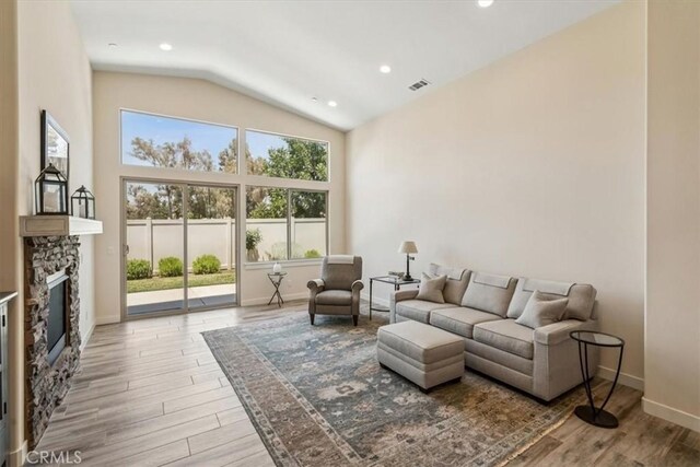 232 Loretta Way, Calimesa, CA 92320 - living area with a fireplace, wood finished floors, high vaulted ceiling, and recessed lighting