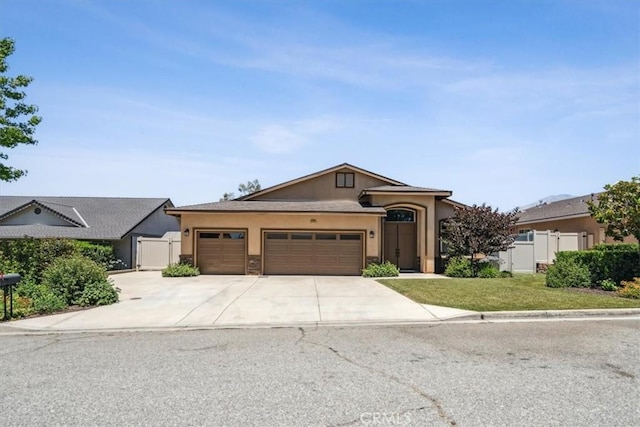 232 Loretta Way, Calimesa, CA 92320 - view of front of property with stucco siding, a garage, and concrete driveway