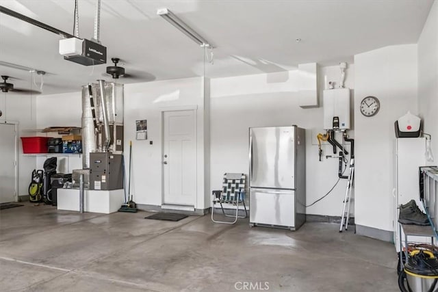 232 Loretta Way, Calimesa, CA 92320 - garage featuring freestanding refrigerator, a garage door opener, and water heater