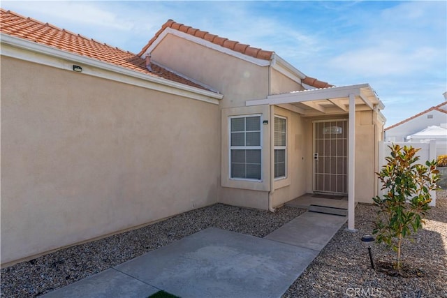 28076 Orangegrove Ave, Menifee, CA 92584 - entrance to property featuring a patio area, stucco siding, and a tiled roof