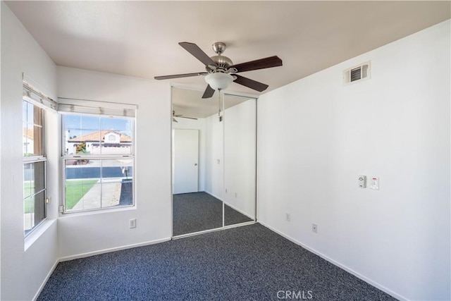28076 Orangegrove Ave, Menifee, CA 92584 - unfurnished bedroom with multiple windows, carpet floors, and ceiling fan