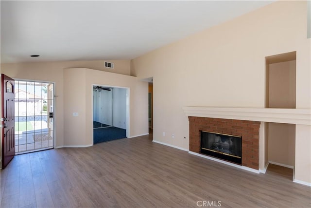 28076 Orangegrove Ave, Menifee, CA 92584 - unfurnished living room with wood finished floors, lofted ceiling, a brick fireplace, and ceiling fan