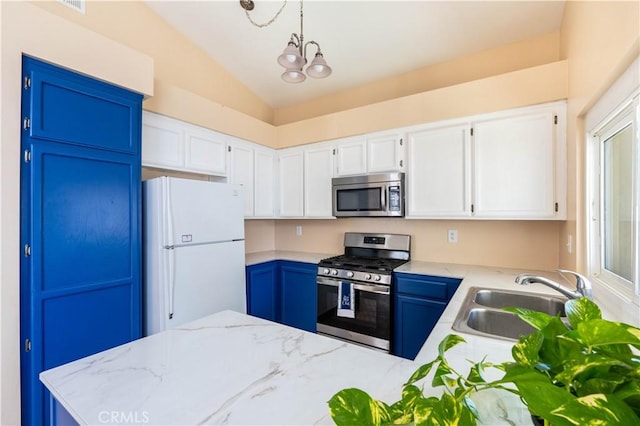 28076 Orangegrove Ave, Menifee, CA 92584 - kitchen featuring appliances with stainless steel finishes, vaulted ceiling, white cabinets, light stone counters, and a chandelier