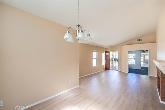 28076 Orangegrove Ave, Menifee, CA 92584 - unfurnished living room featuring a chandelier, plenty of natural light, vaulted ceiling, and light wood-style flooring