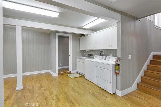 625 High Dr, Laguna Beach, CA 92651 - laundry room featuring cabinet space, light wood-type flooring, and washer and clothes dryer
