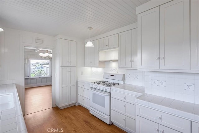625 High Dr, Laguna Beach, CA 92651 - kitchen featuring white gas stove, tile countertops, light wood-style flooring, and tasteful backsplash