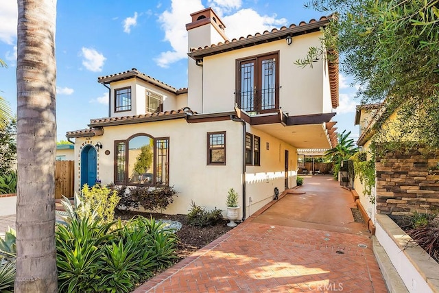 34283 Via Lopez, Dana Point, CA 92624 - mediterranean / spanish-style home with a balcony, a chimney, stucco siding, french doors, and a tiled roof
