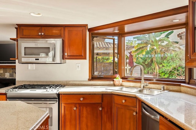 34283 Via Lopez, Dana Point, CA 92624 - kitchen featuring appliances with stainless steel finishes, brown cabinets, and light stone countertops