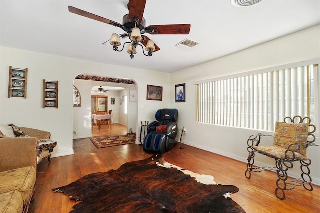 4234 Center Ave, Norco, CA 92860 - living area featuring arched walkways, a ceiling fan, and wood finished floors