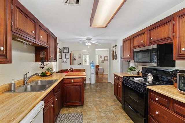 4234 Center Ave, Norco, CA 92860 - kitchen with black range with gas cooktop, stainless steel microwave, white dishwasher, a ceiling fan, and a peninsula