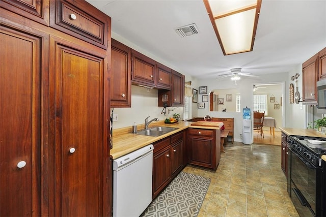 4234 Center Ave, Norco, CA 92860 - kitchen with white dishwasher, black range oven, ceiling fan, light countertops, and a peninsula
